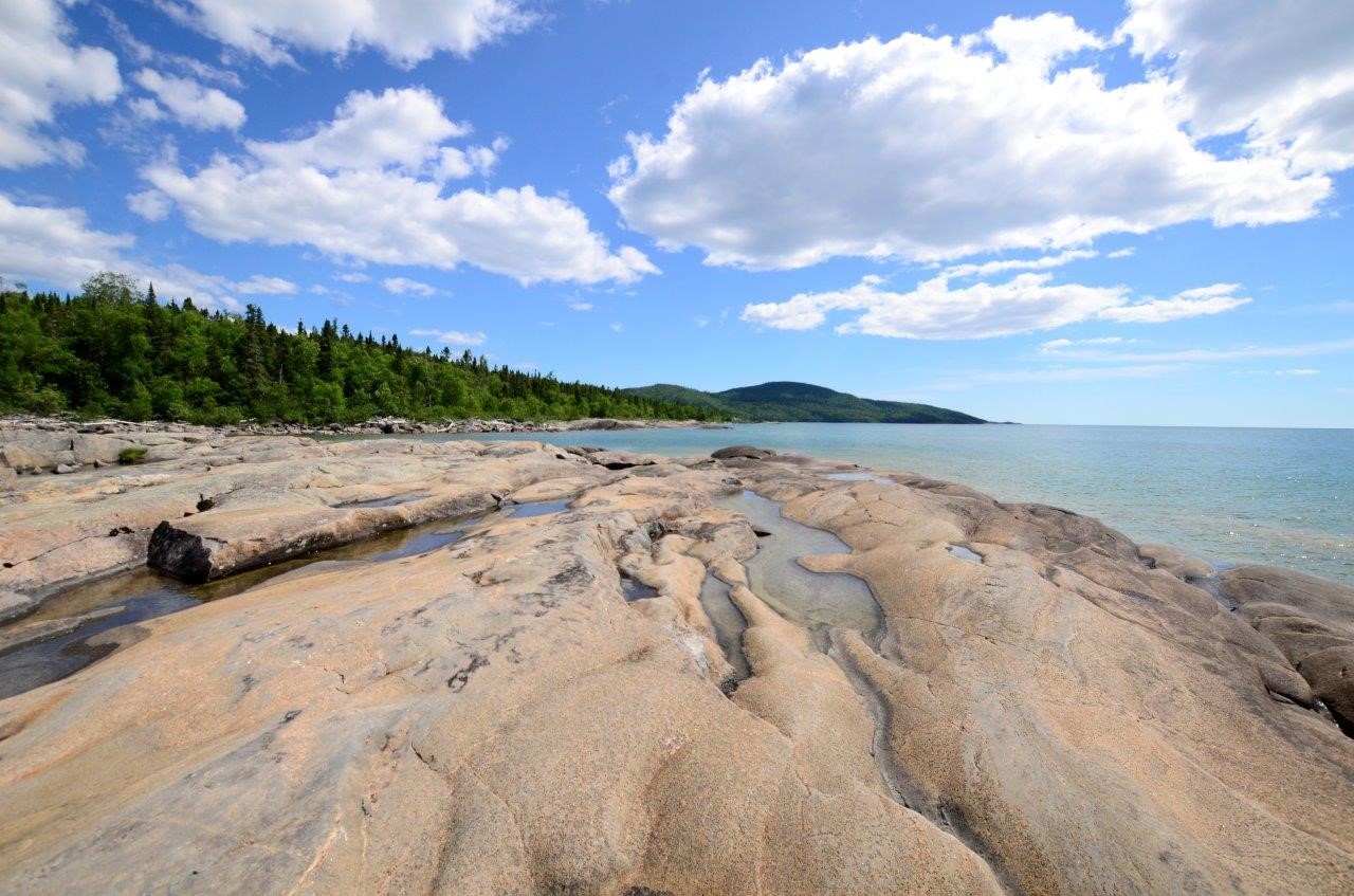rocky shoreline of Lake Superior under blue sky