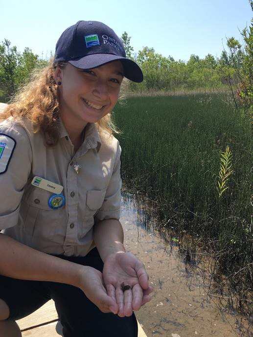Discovery Guide smiling and holding frog