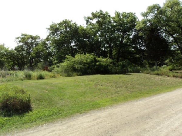 View of site 108 shows a wide open space, lots of grass, few trees surrounding it.