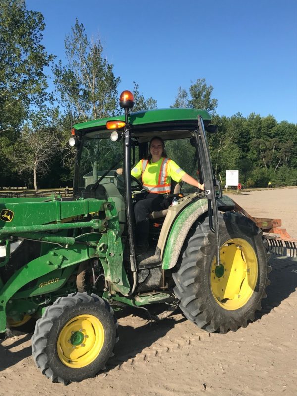 staff driving tractor