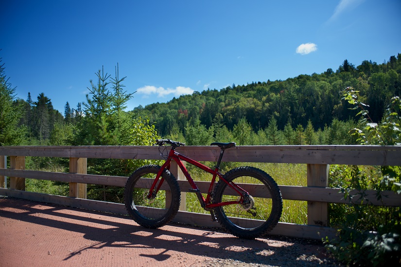 Bike leans against railing on trail