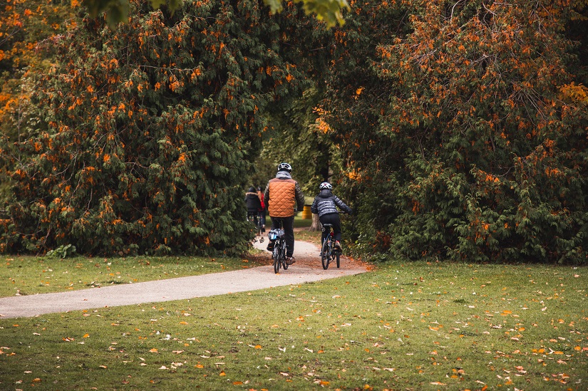 Two people on a bike ride in fall.