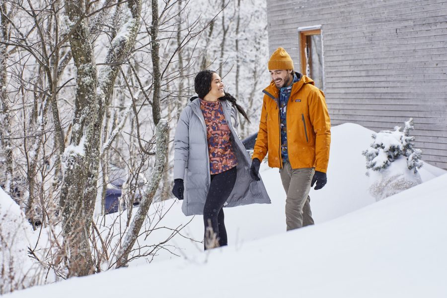 man and woman walking in snow