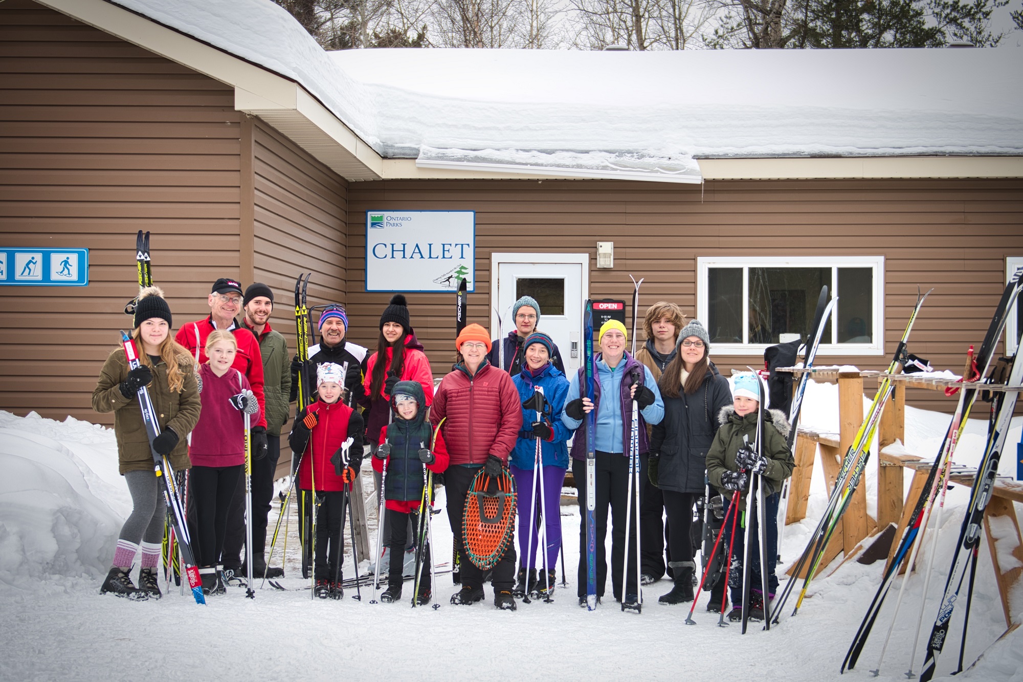 group of skiers standing in front of chalet