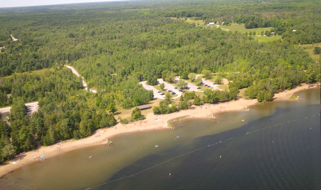aerial view of lake, shoreline, campground and forest