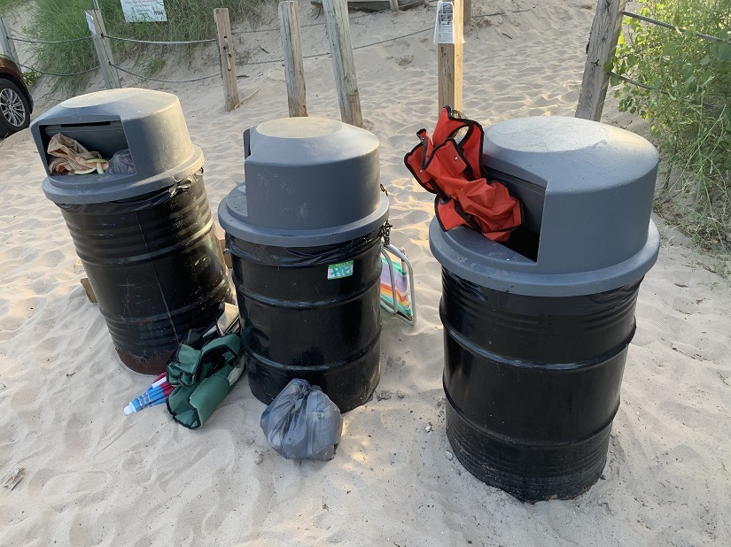 Garbage cans with camp chairs stuffed in