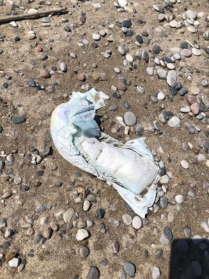 Diaper thrown on the ground at a beach