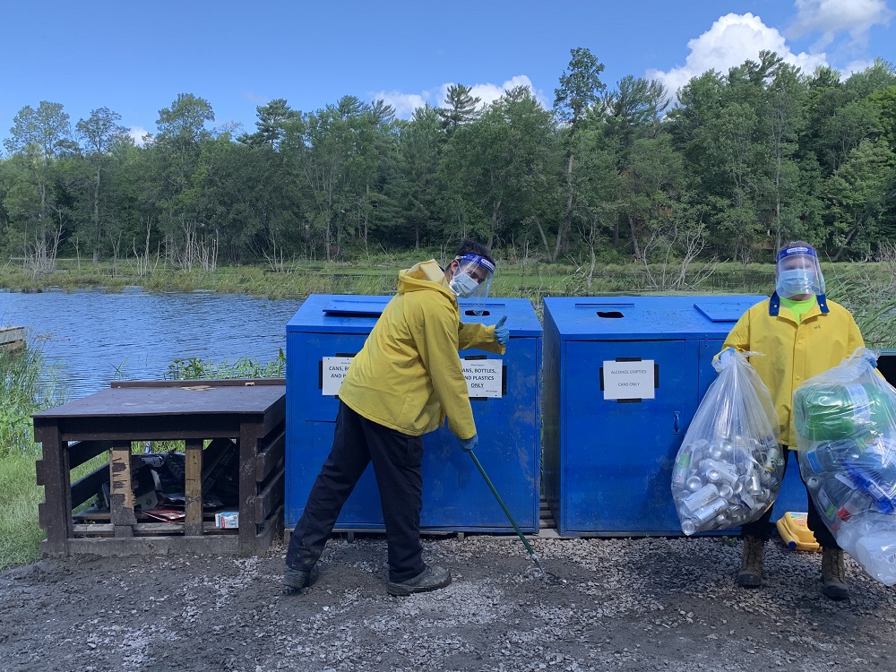 staff cleaning trash