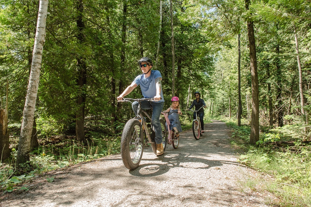 family biking on trail