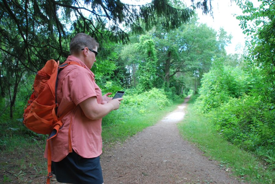 hiker using Adventure Lab app while on trail