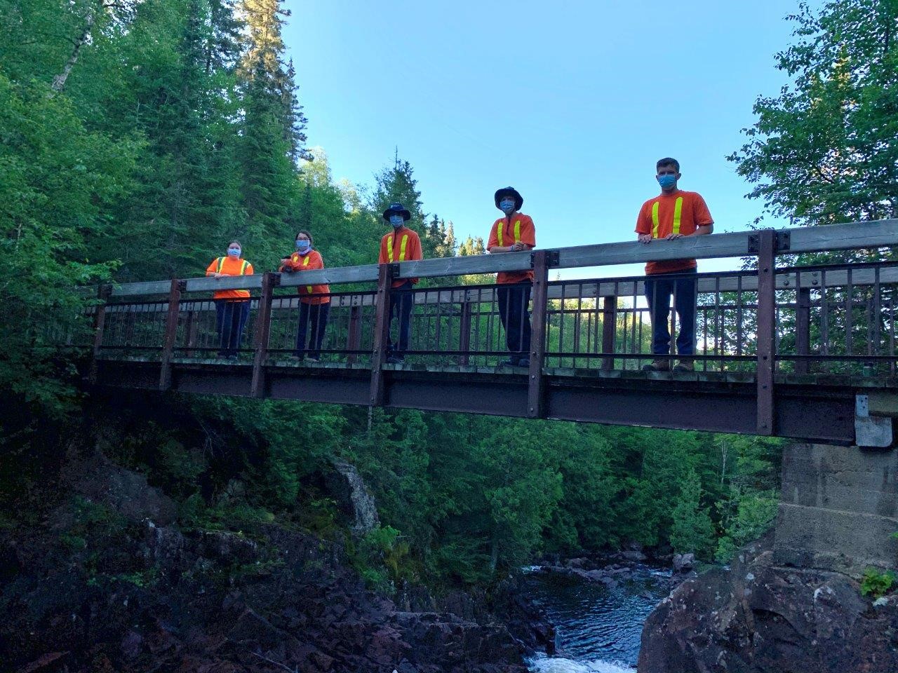 staff standing on bridge