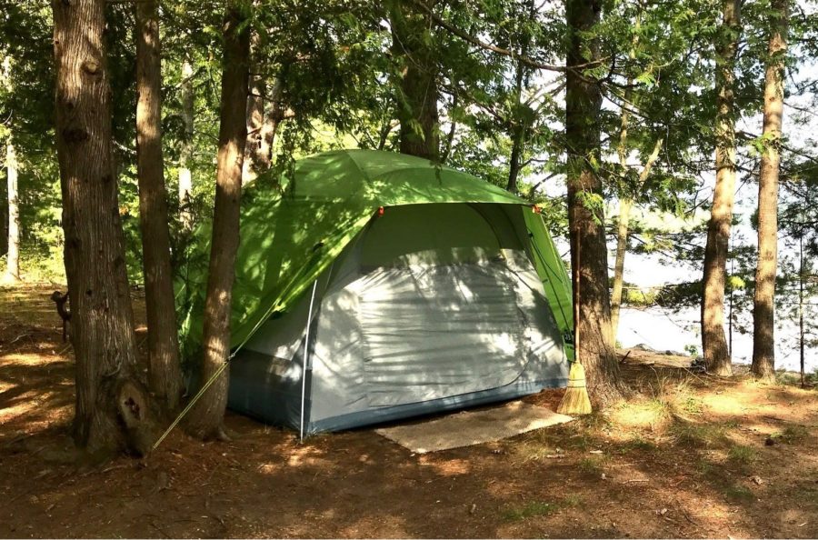 Tent in a wooded area next to a lake