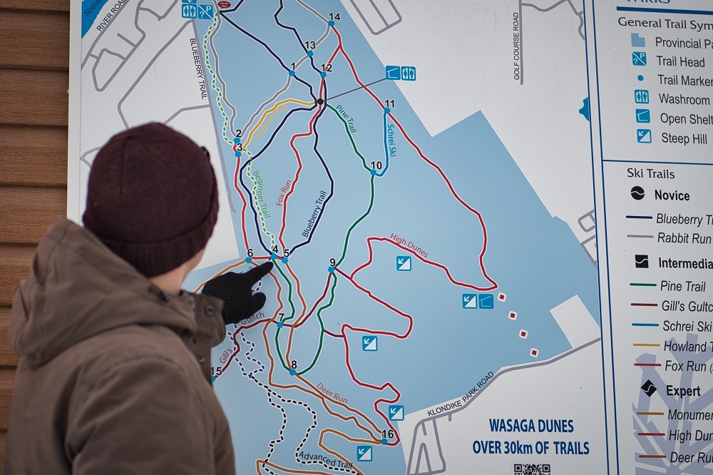 person looking at maps trails