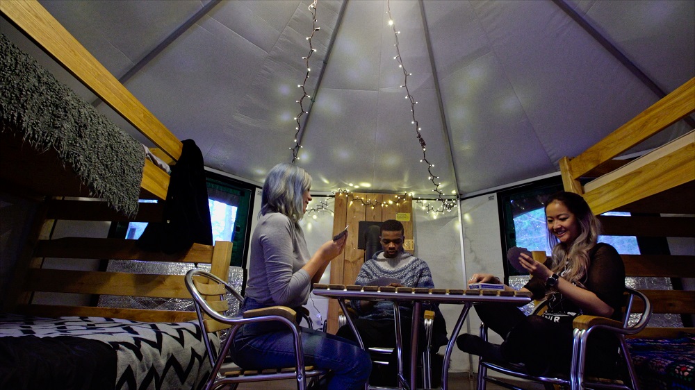 people playing cards in yurt
