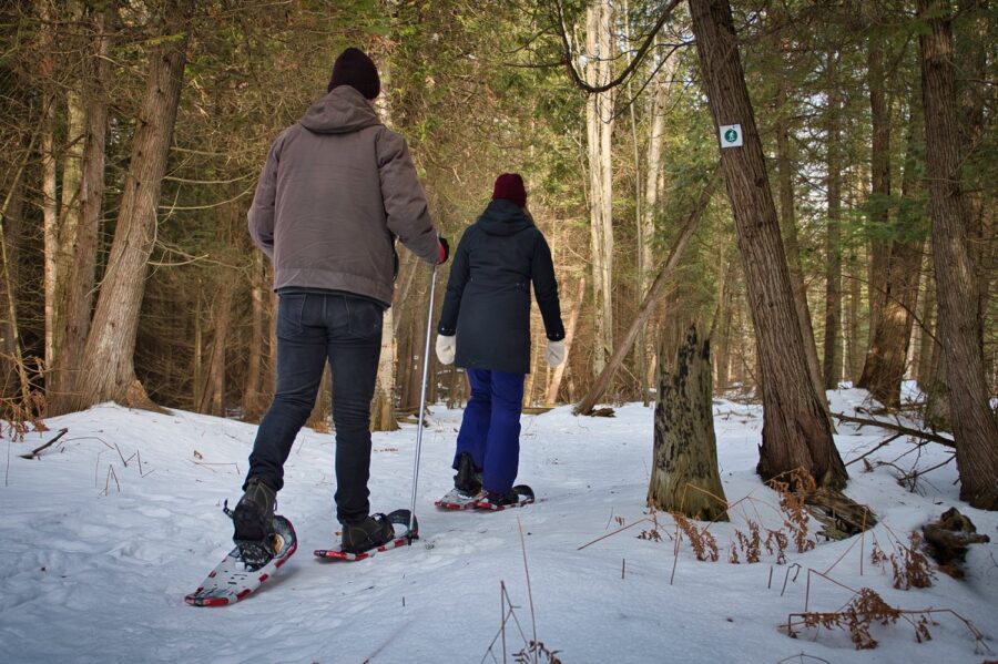 Couple snowshoeing along trail