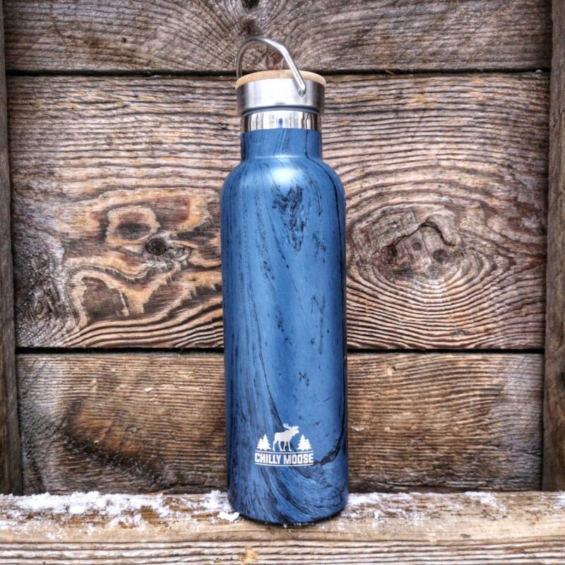 Chilly Moose stainless steel water bottle in front of rustic wooden wall