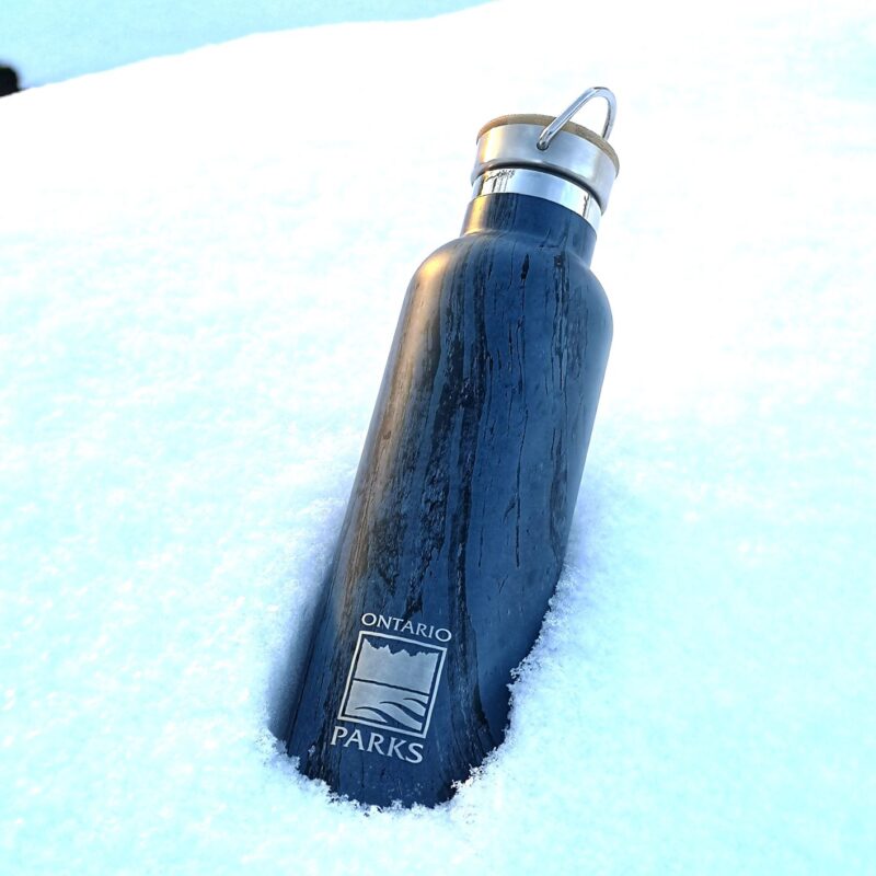 Chilly Moose stainless steel water bottle with Ontario parks logo set in the snow