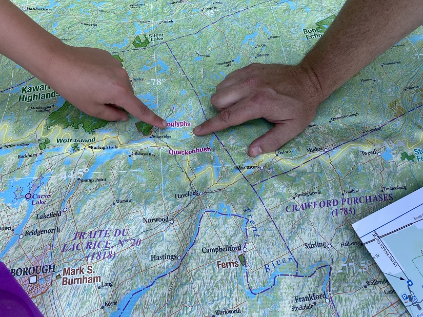 Hands pointing at map.