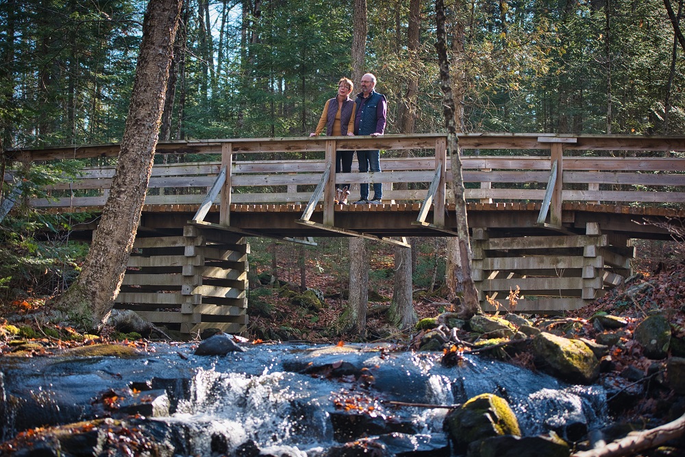 Un couple profite de la vue sur le pont au point d’entrée du sentier de randonnée pédestre.