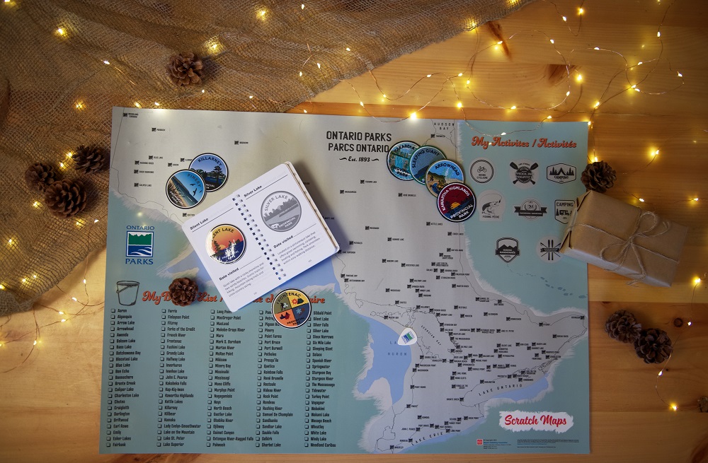 passport, crests, and stickers on scratch map