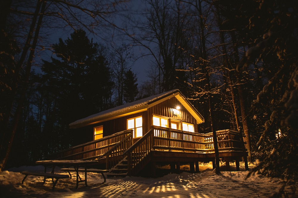 exterior of cabin at night, lit from within