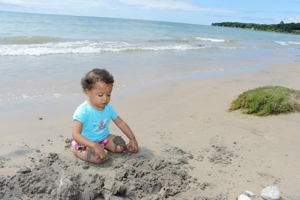child sitting on beach