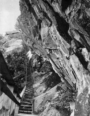 Vintage photo of staircase on side of cliff.