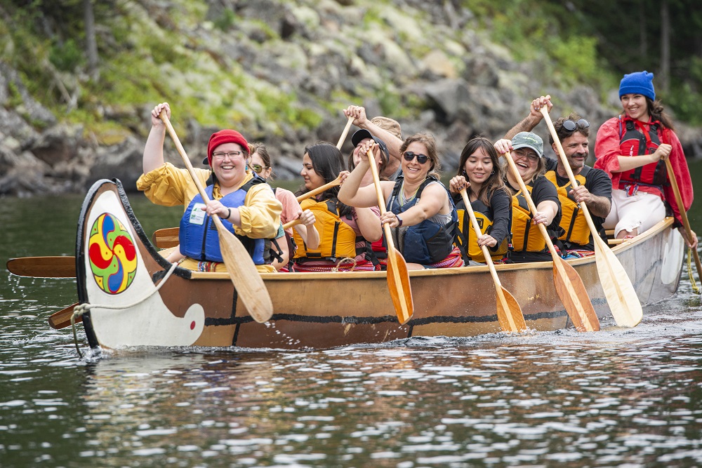 Voyageur Adventure Tour, paddling canoe down river