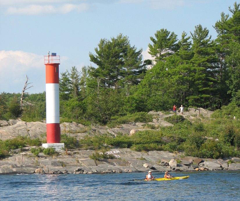 Lighthouse on a rocky shoreline.