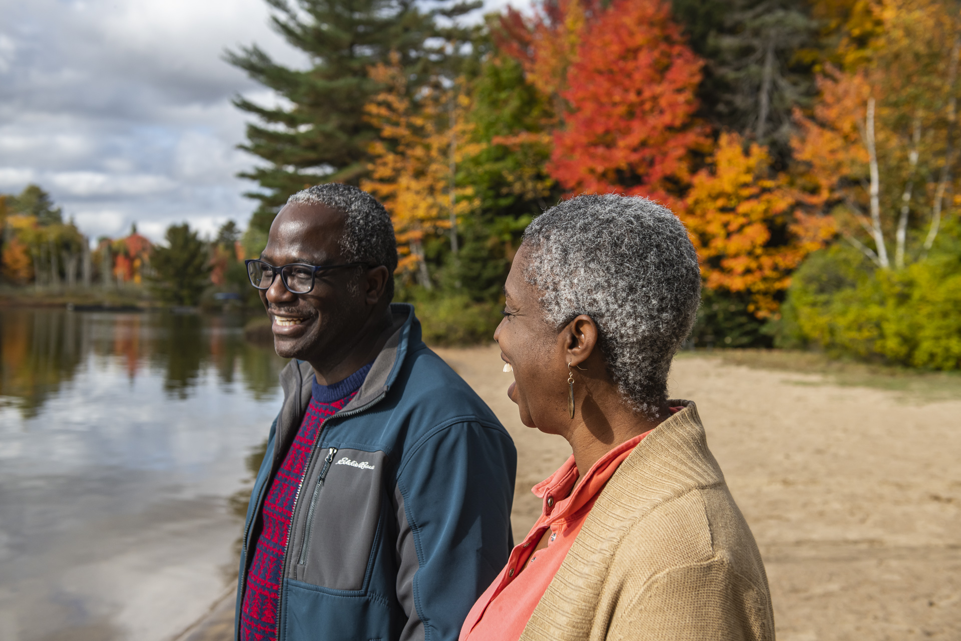 Couple on beach during peak fall colours