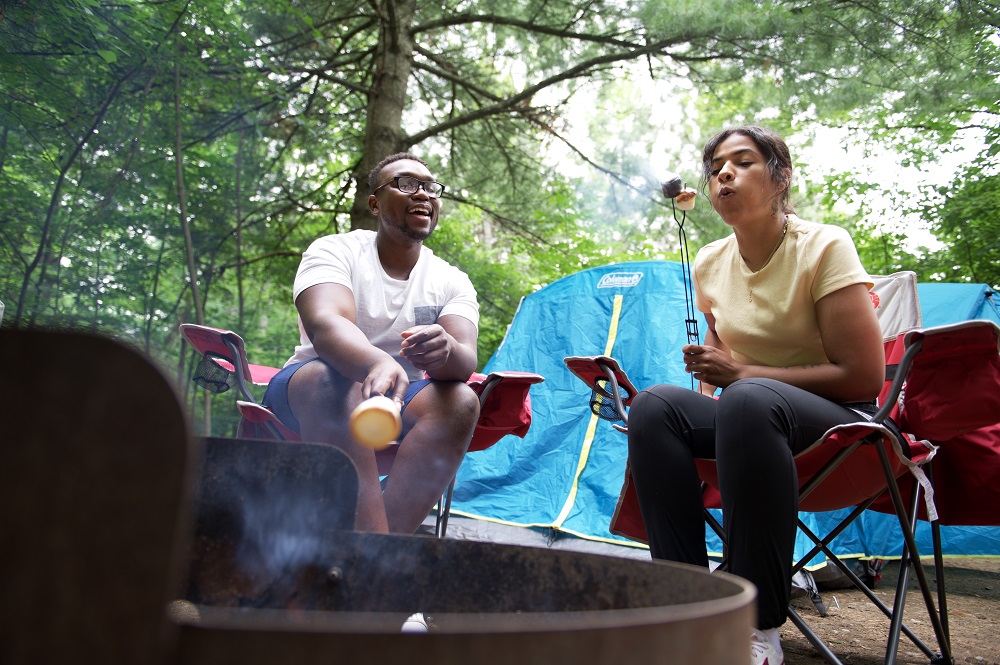 couple sitting around campfire