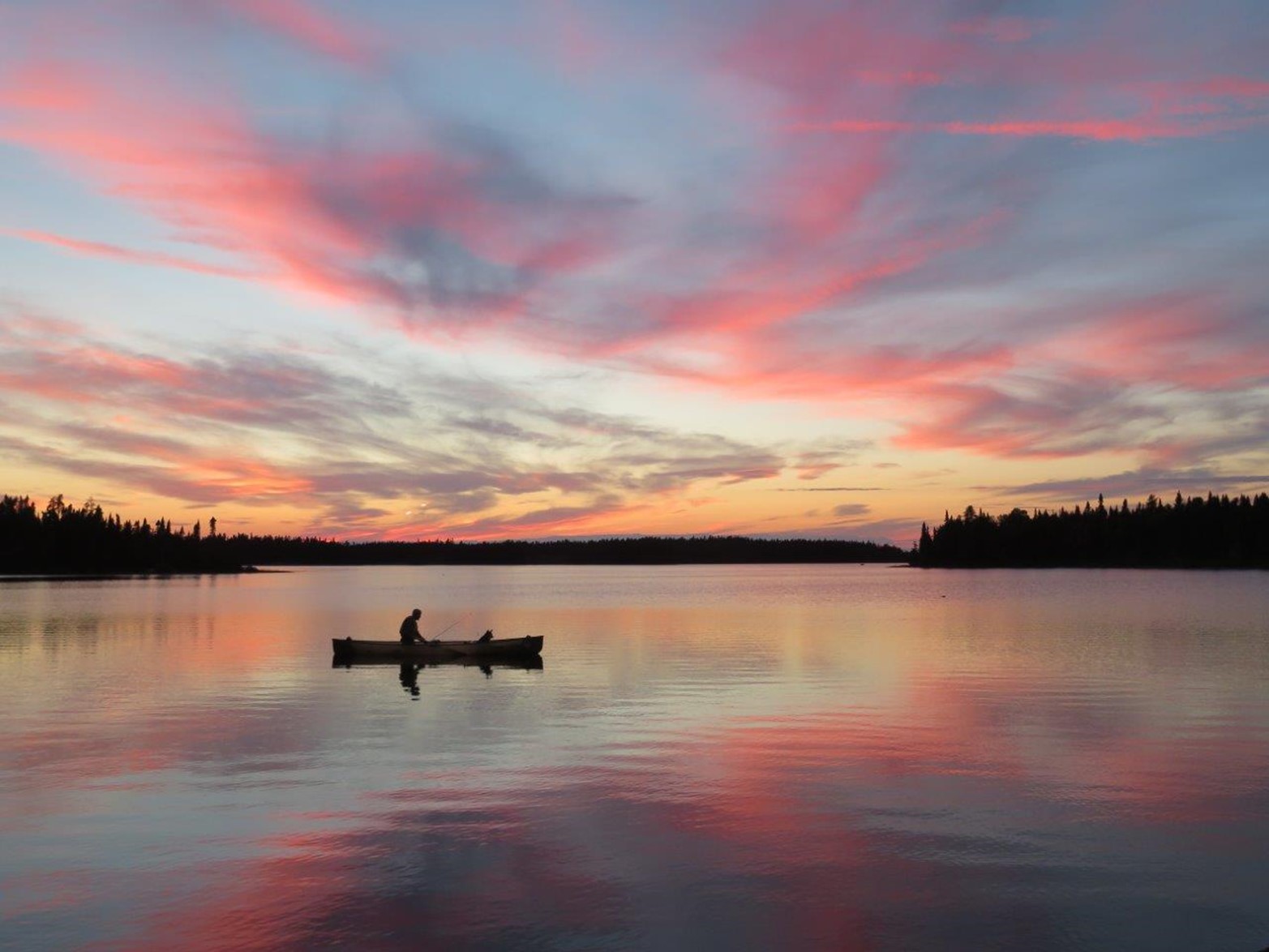 canoe on lake at sunset