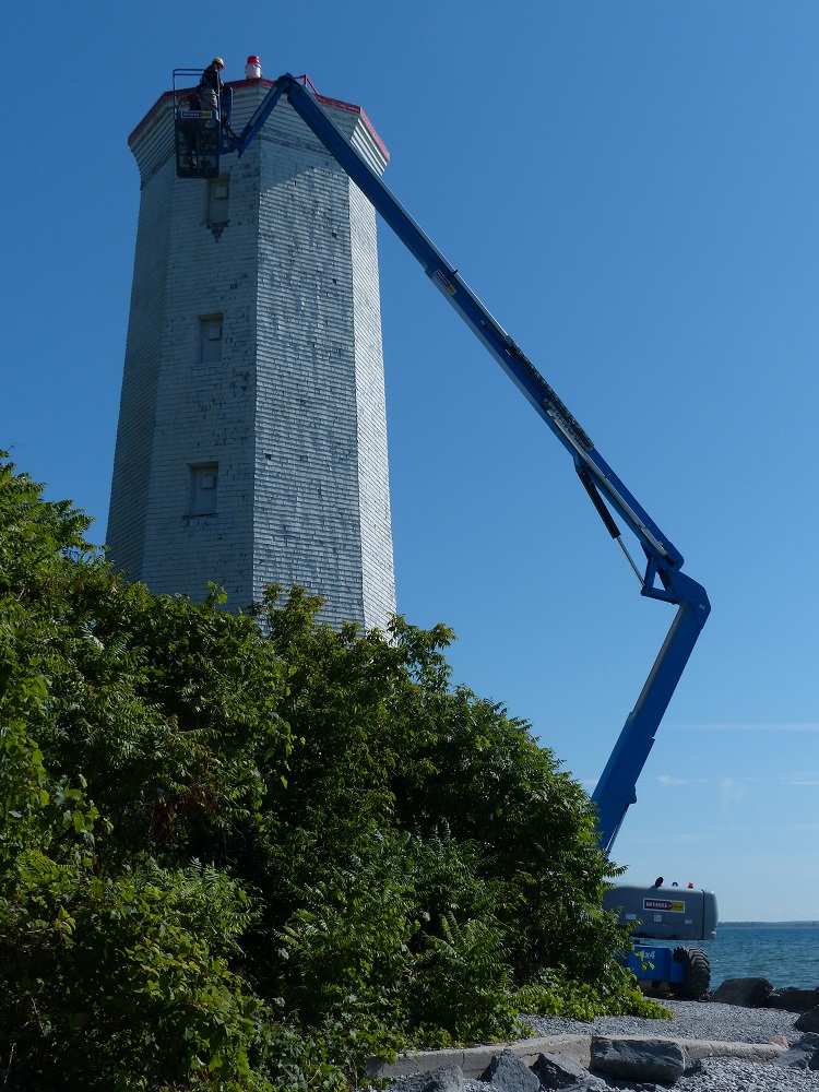 crane inspecting lighthouse