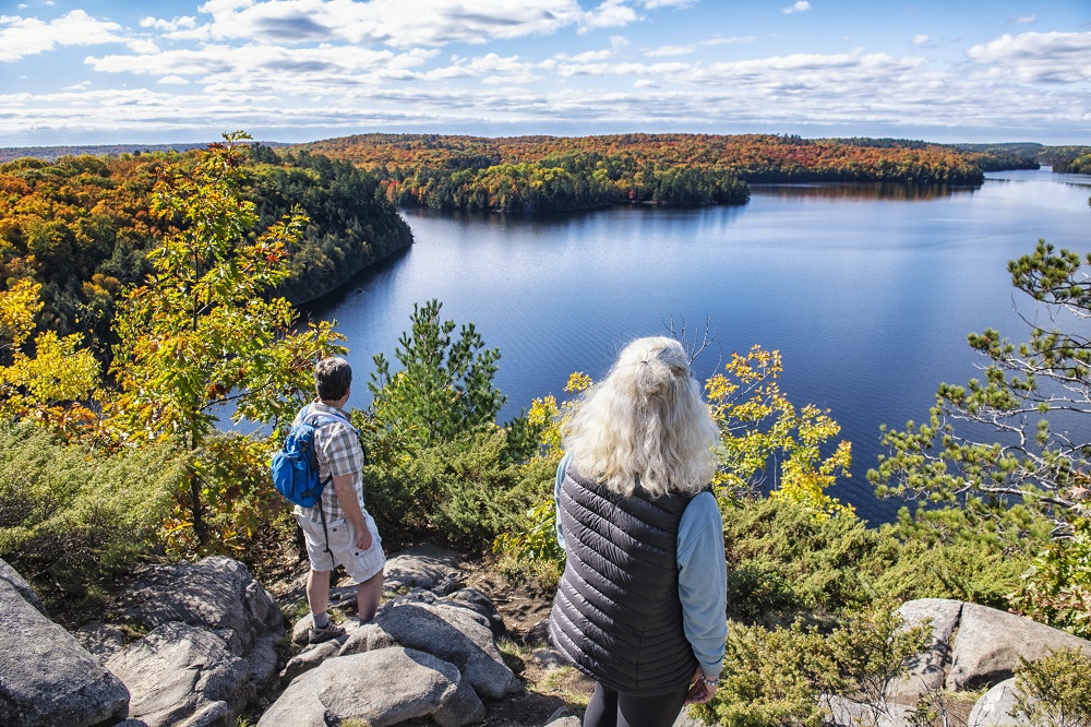 hikers at lookout with fall colours