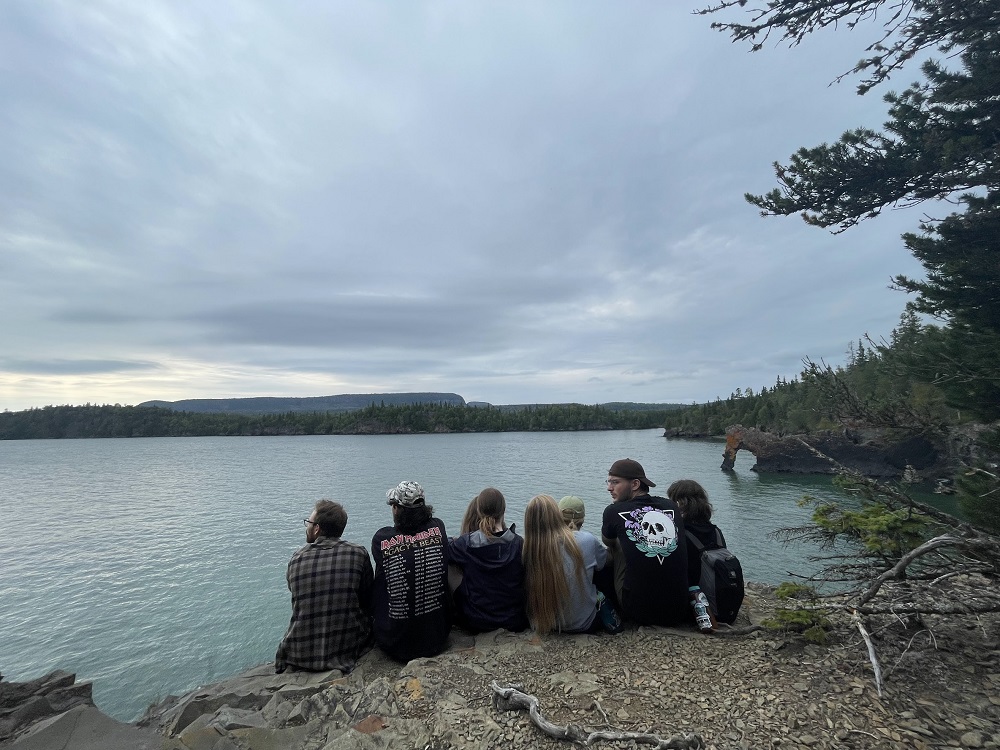 group of staff sitting on lake edge