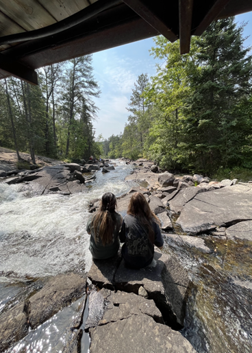 two people looking at river