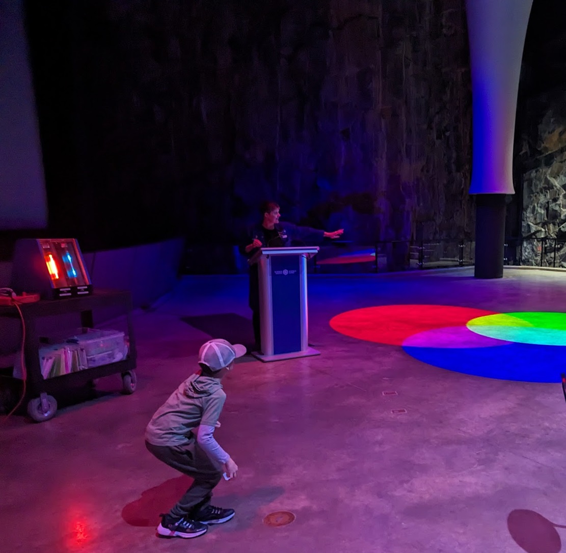 child looking at colours projected on floor