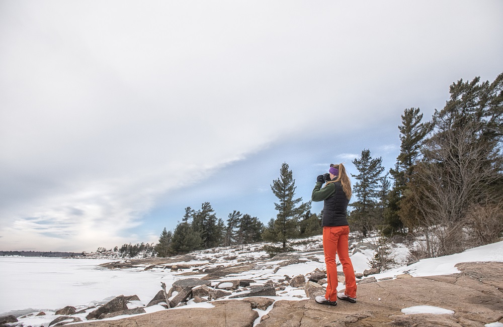 person taking photo of landscape at winter