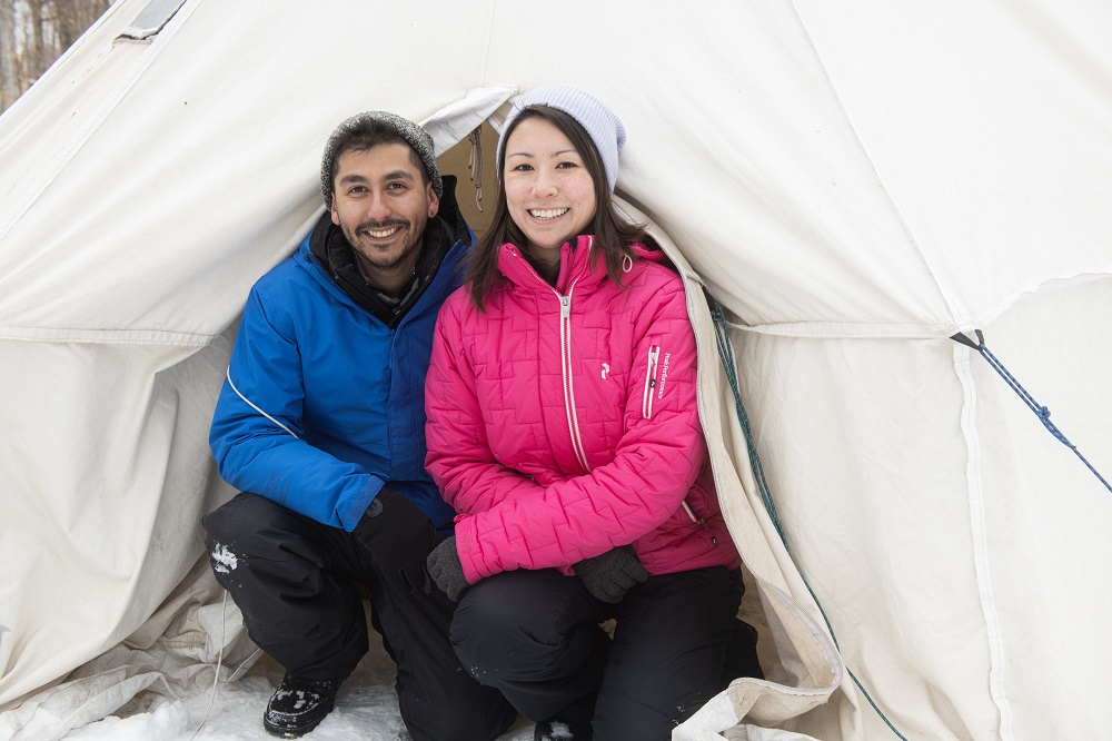 Couple hot tenting in winter