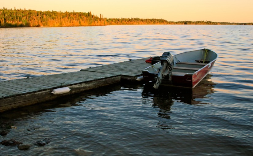 a motorboat floating beside a dock in Fushimi Lake Provincial Park.