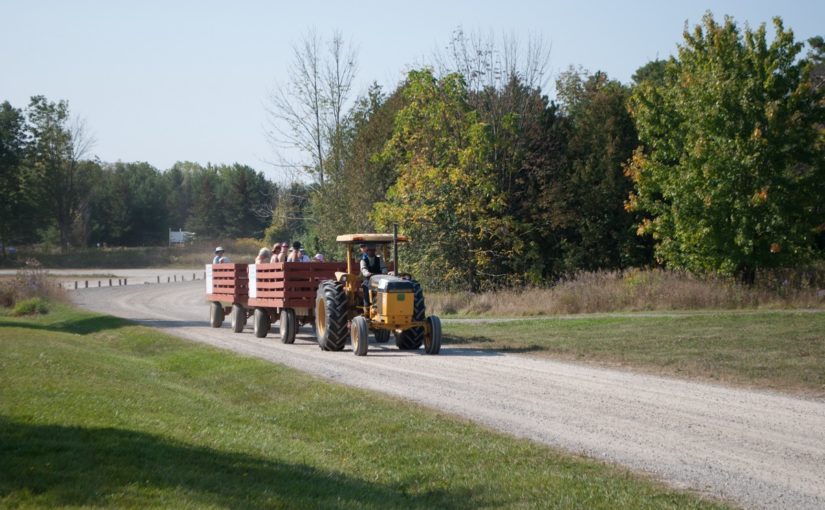 Tractor pulling wagons full of visitors on a tour of the farm.