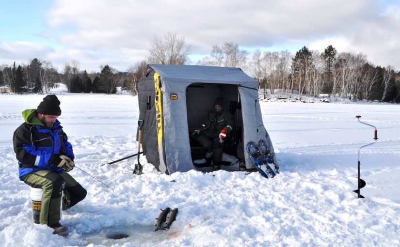 Man ice fishes on Windy lake