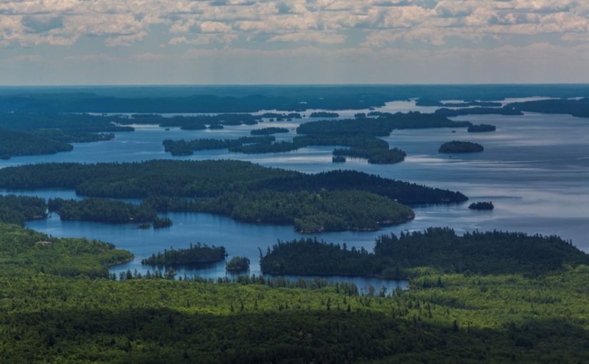 An areal view of a lake land with scattered forested islands
