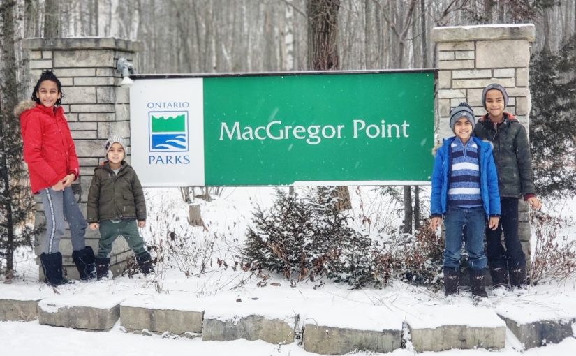 Children standing in front of a MacGregor Point sign