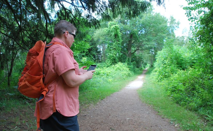 hiker using Adventure Lab app while on trail