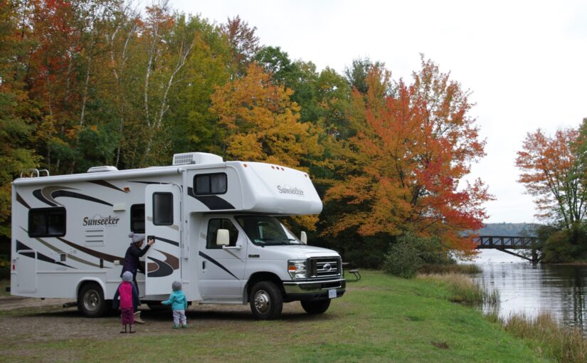 Family with RV during fall colours