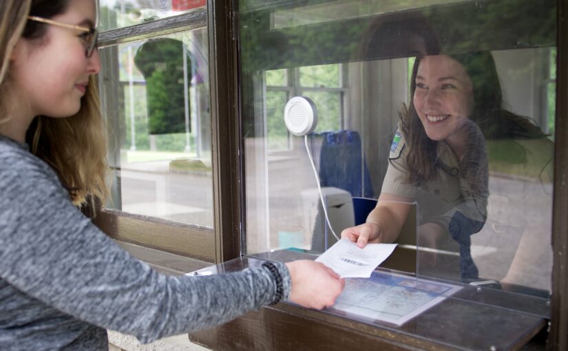 A visitor obtains their vehicle permit at Emily Provincial Park's gatehouse.