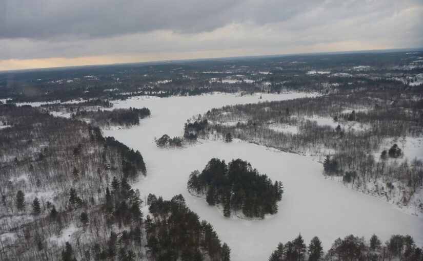 aerial of lake covered in snow