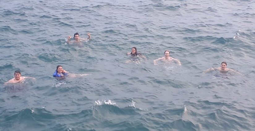 group swimming in lake